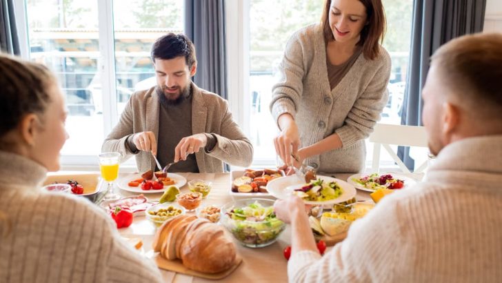 Four friends sharing a delightful meal indoors, highlighting friendship and togetherness.